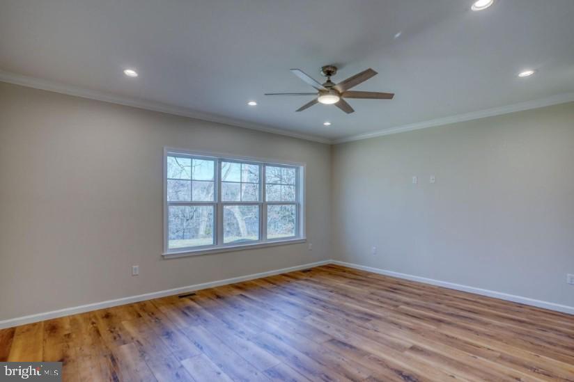 39 Doc Court Felton, DE 19943 - Photo 37 of 70 an empty room with wooden floor fan and windows