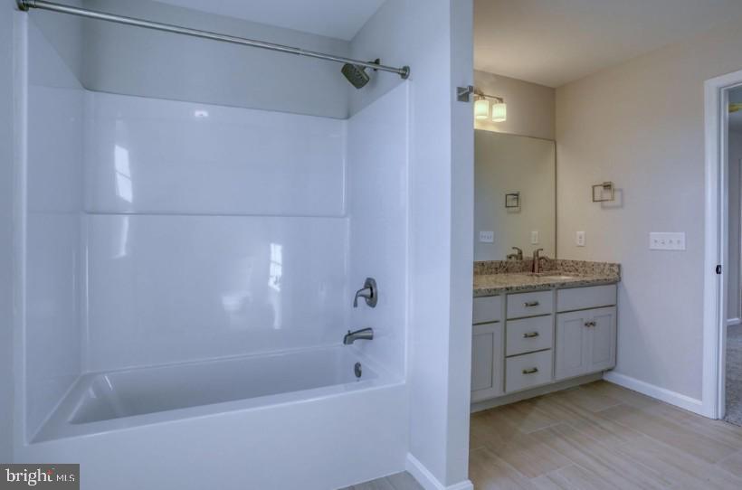 39 Doc Court Felton, DE 19943 - Photo 55 of 70 a bathroom with a granite countertop sink a mirror bathtub and shower