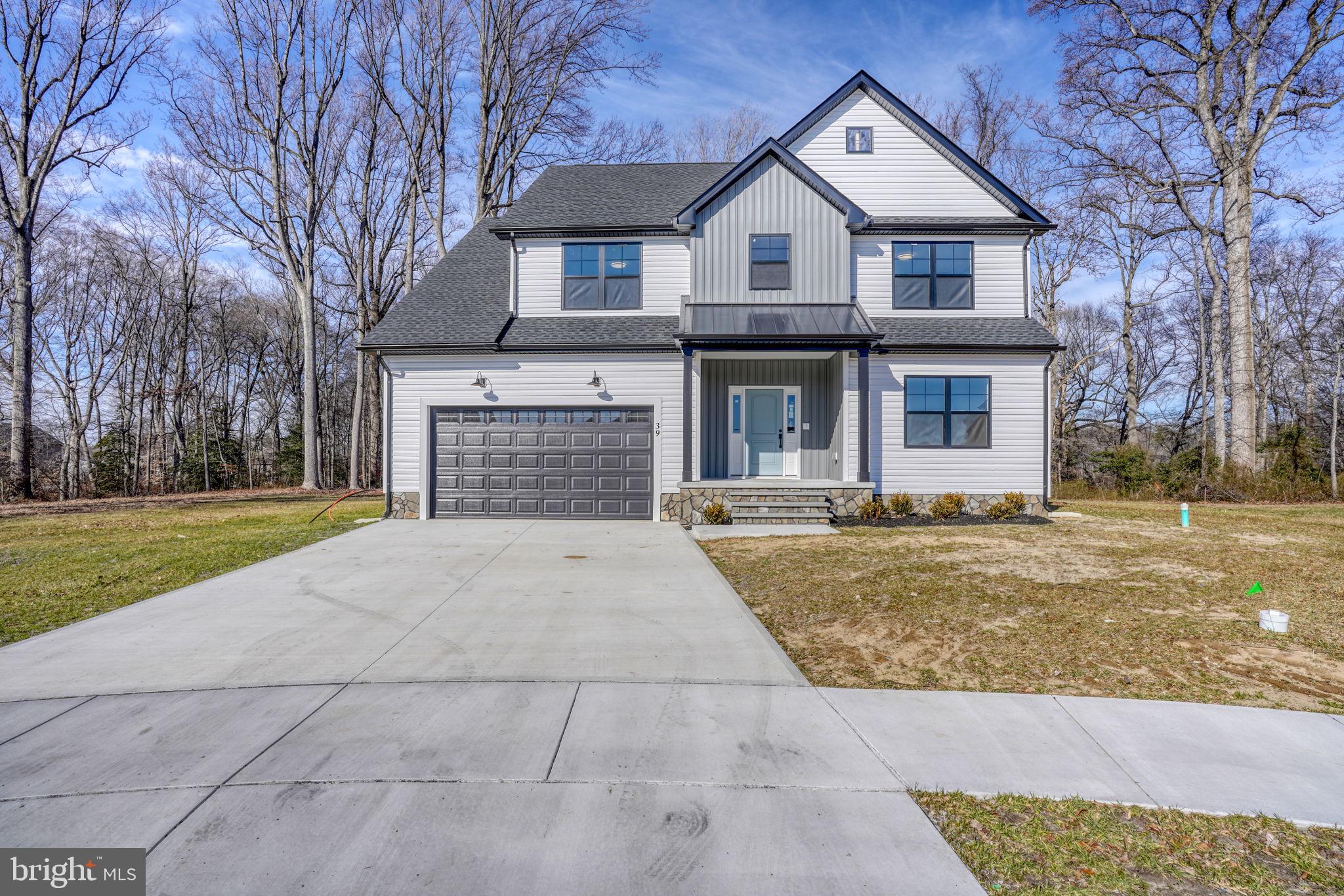39 Doc Court Felton, DE 19943 - Photo 7 of 70 a front view of a house with a yard and garage