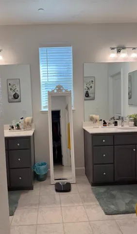 a bathroom with a sink vanity and mirror