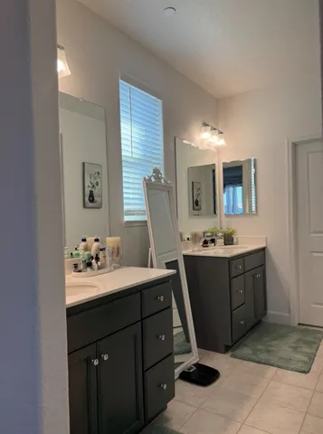 a bathroom with a double vanity sink and mirror