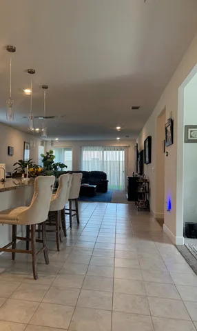 a kitchen with a sink a counter and chairs kitchen view