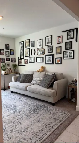 a living room with furniture and painting on the wall