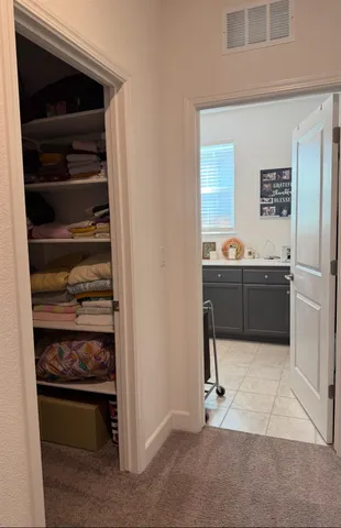 a kitchen with a refrigerator and cabinets