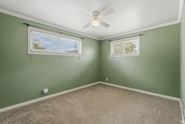 378 West 200 South Bountiful, UT 84010 - Photo 14 of 32 Room featuring two windows with horizontal blinds, a ceiling fan with integrated lighting, crown molding, and neutral-toned carpeting