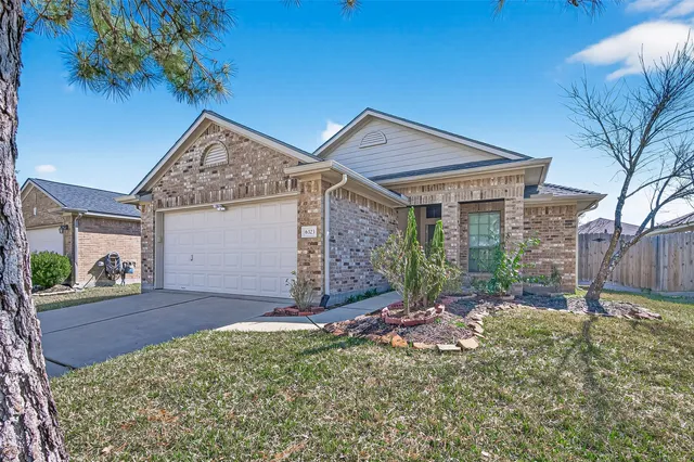 a view of a house with a small yard and floor to ceiling window