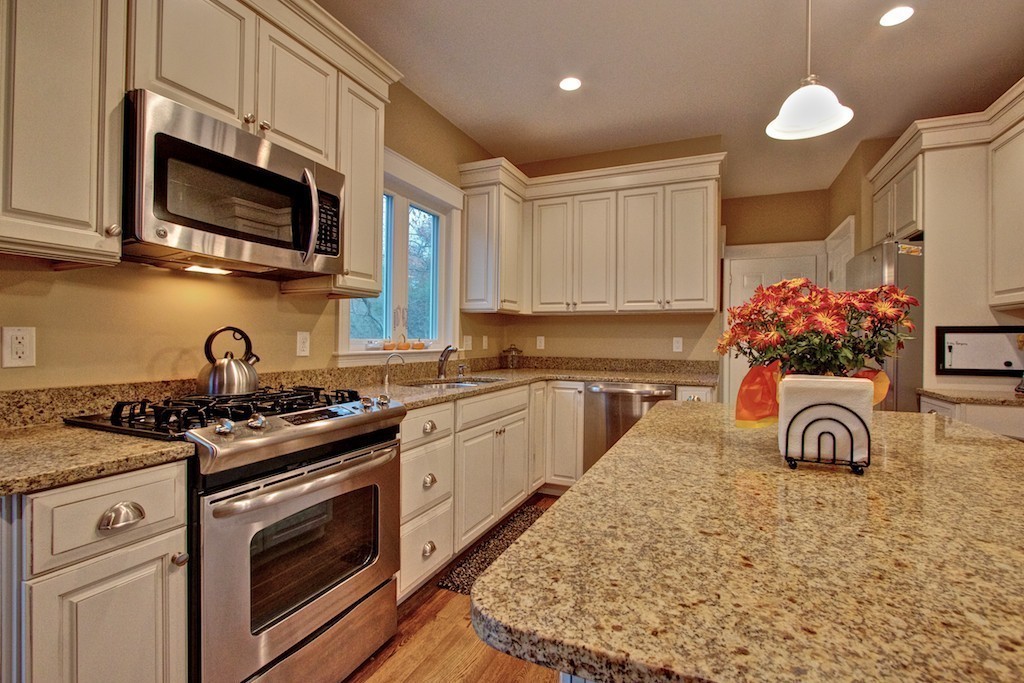 550 Edgell Road Framingham, MA 01701 - Photo 8 of 29 a kitchen with stainless steel appliances granite countertop a stove a sink and a microwave