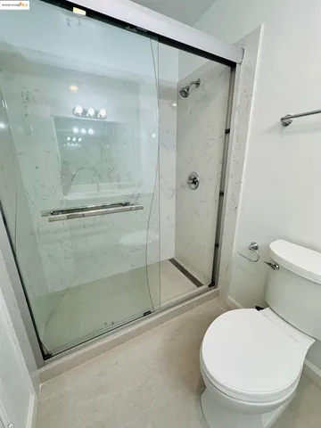 a bathroom with a toilet and a shower