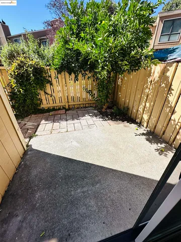 a view of a backyard with a tree