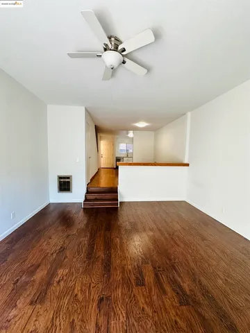 a view of an empty room and wooden floor