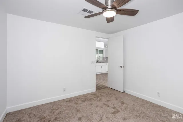 an empty room with a empty space and a ceiling fan