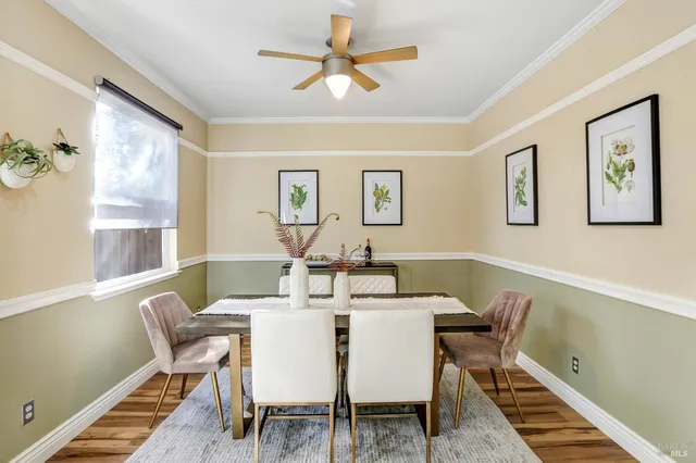 a view of a dining room with furniture and a chandelier