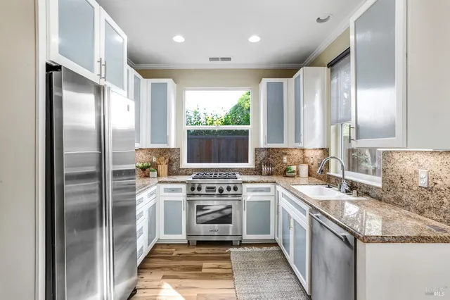 a kitchen with a sink stove and refrigerator