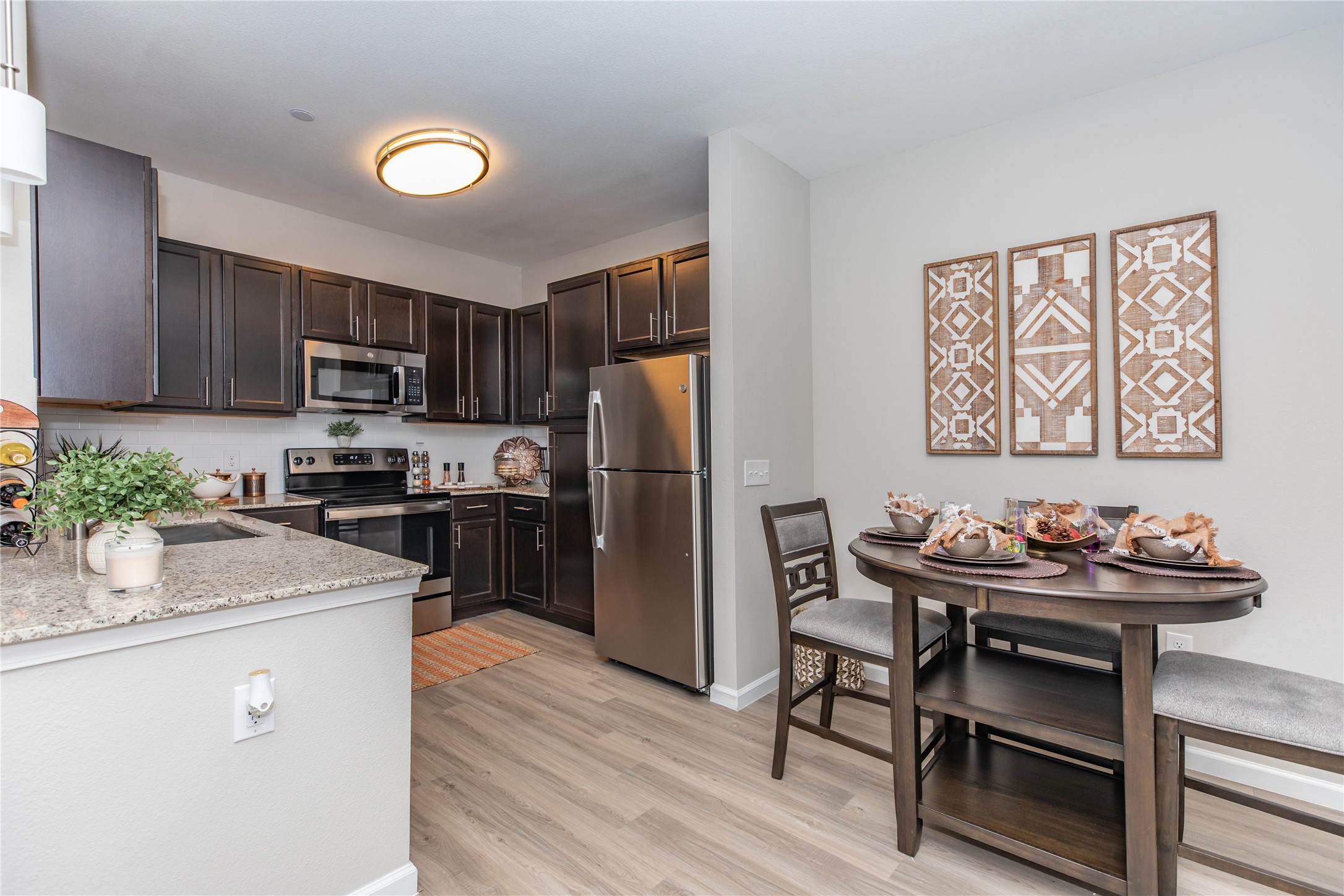 14809 Ralston Road, Unit A18302 Humble, TX 77396 - Photo 3 of 16 a kitchen with a refrigerator and a stove top oven
