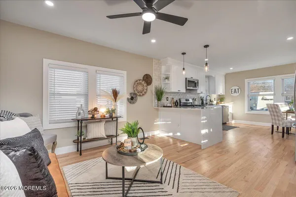 a living room with furniture and kitchen view