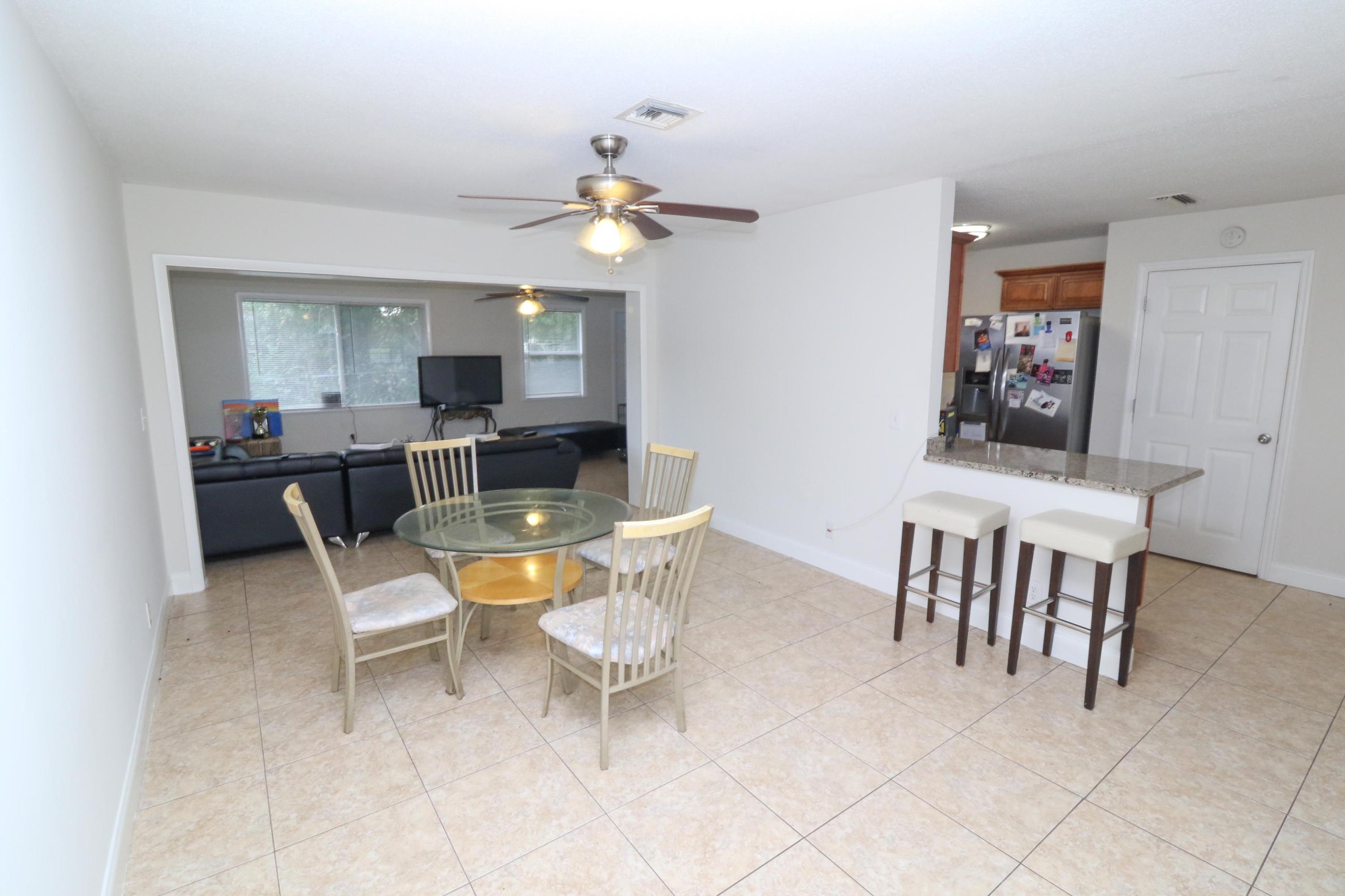 3302 Bermuda Road Palm Beach Gardens, FL 33410 - Photo 2 of 12 a view of a dining room with furniture