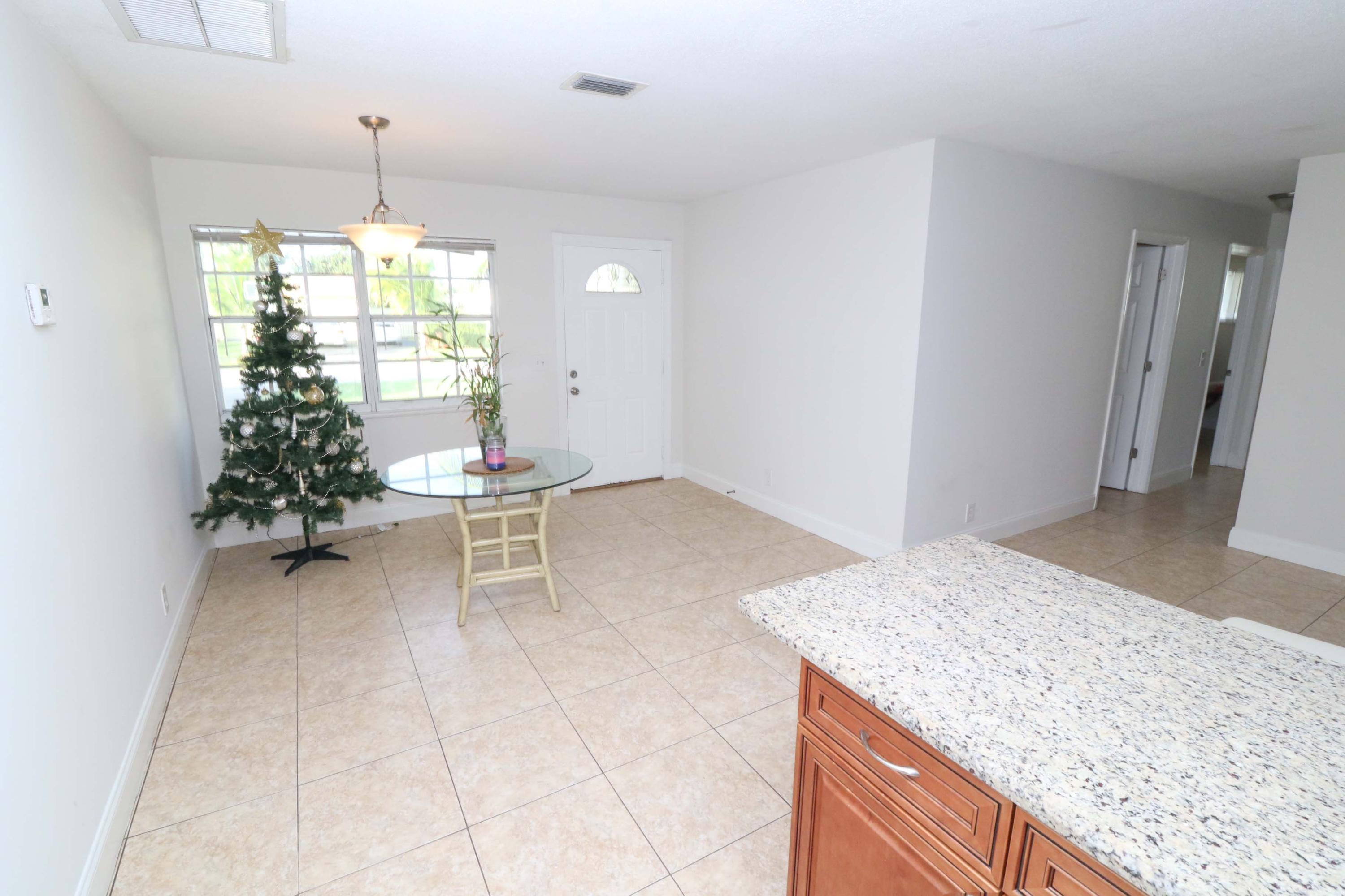 3302 Bermuda Road Palm Beach Gardens, FL 33410 - Photo 5 of 12 a room with a chandelier and chandelier