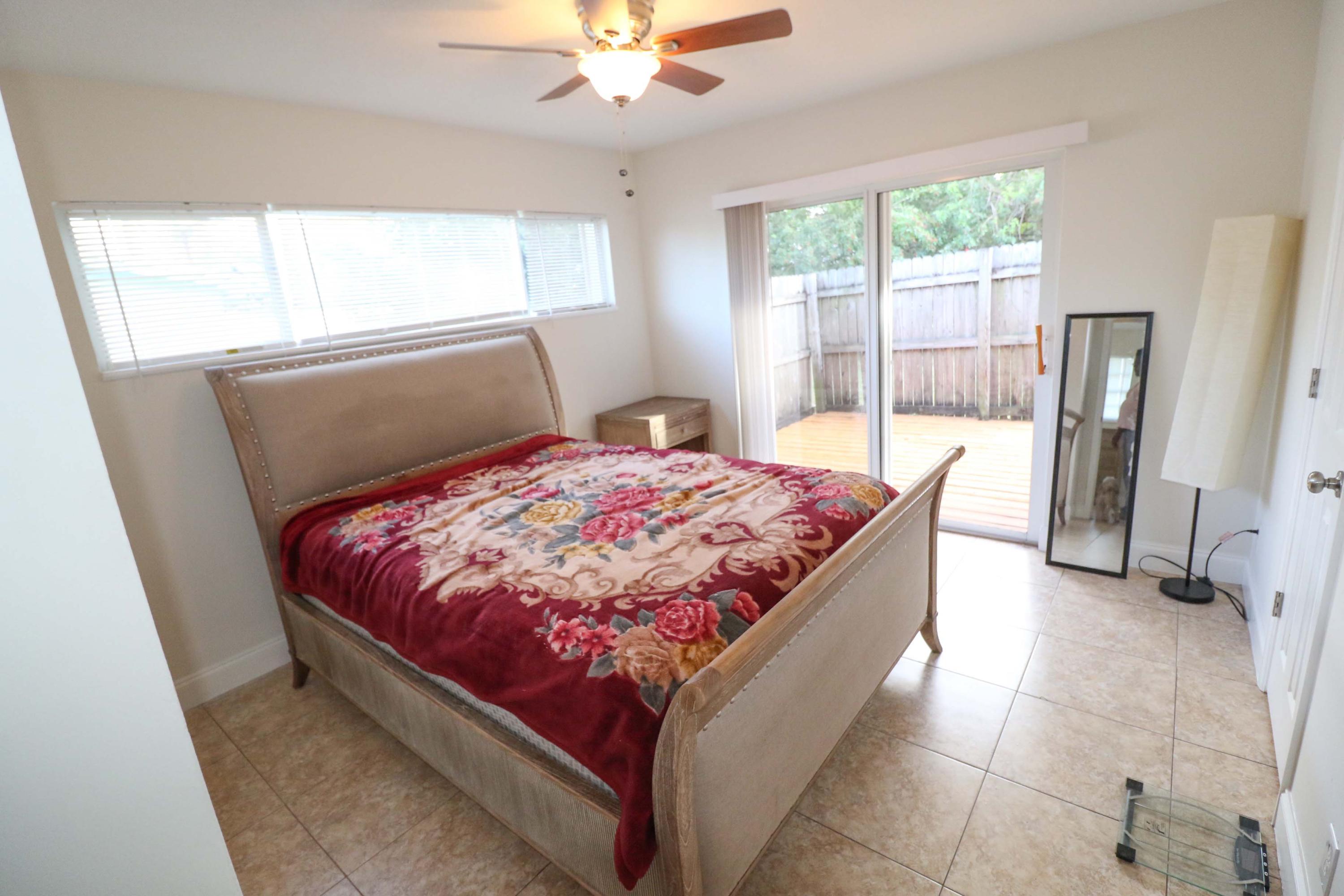 3302 Bermuda Road Palm Beach Gardens, FL 33410 - Photo 8 of 12 a bed sitting in a bedroom next to a window