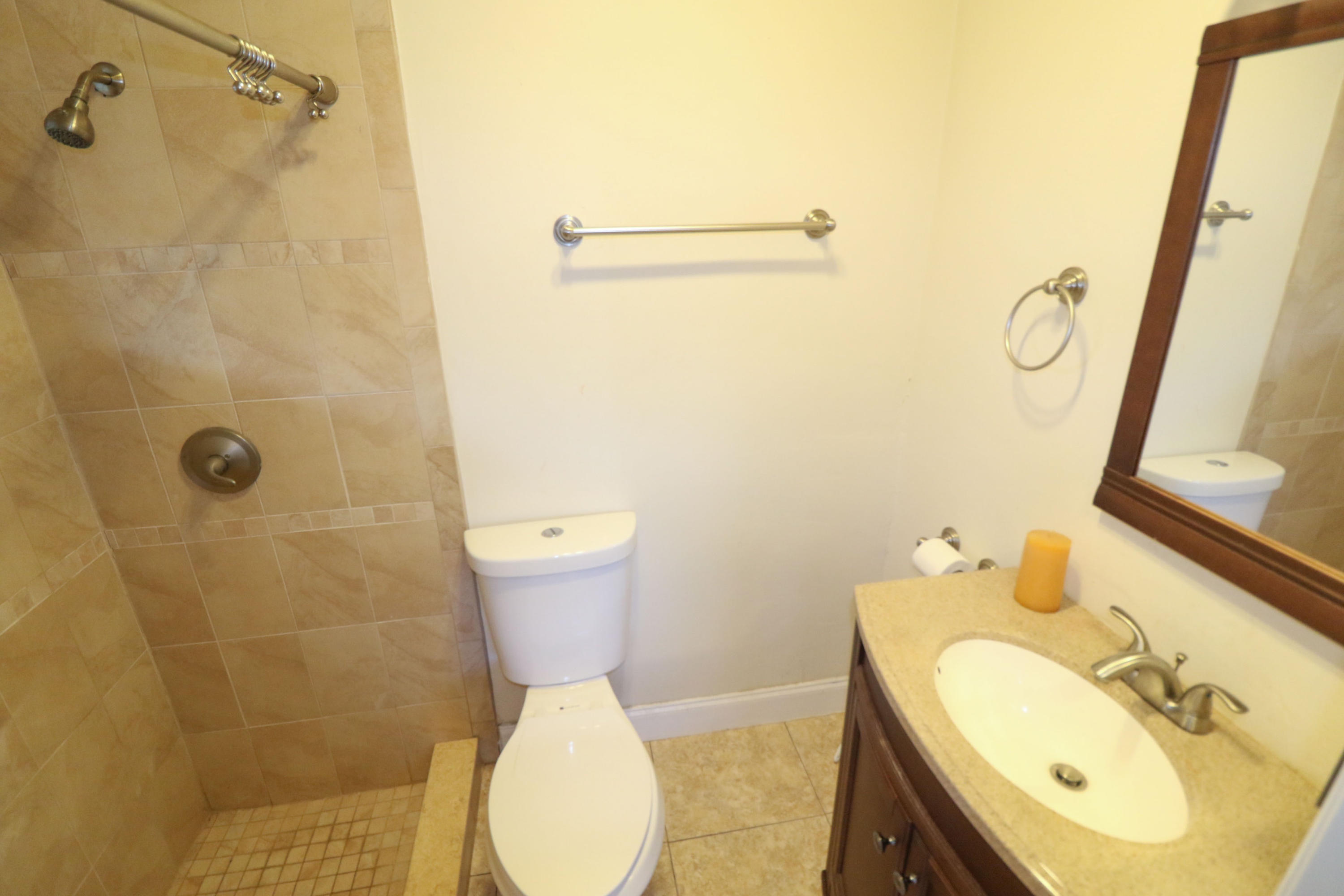 3302 Bermuda Road Palm Beach Gardens, FL 33410 - Photo 9 of 12 a bathroom with a sink toilet and shower