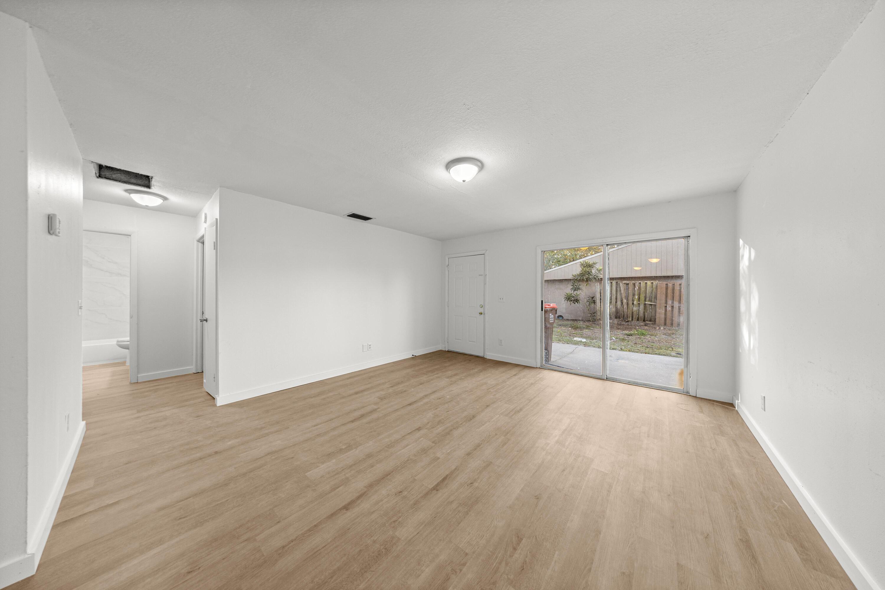 2931 Southeast 52nd Avenue Ocala, FL 34480 - Photo 12 of 52 wooden floor in an empty room with a window