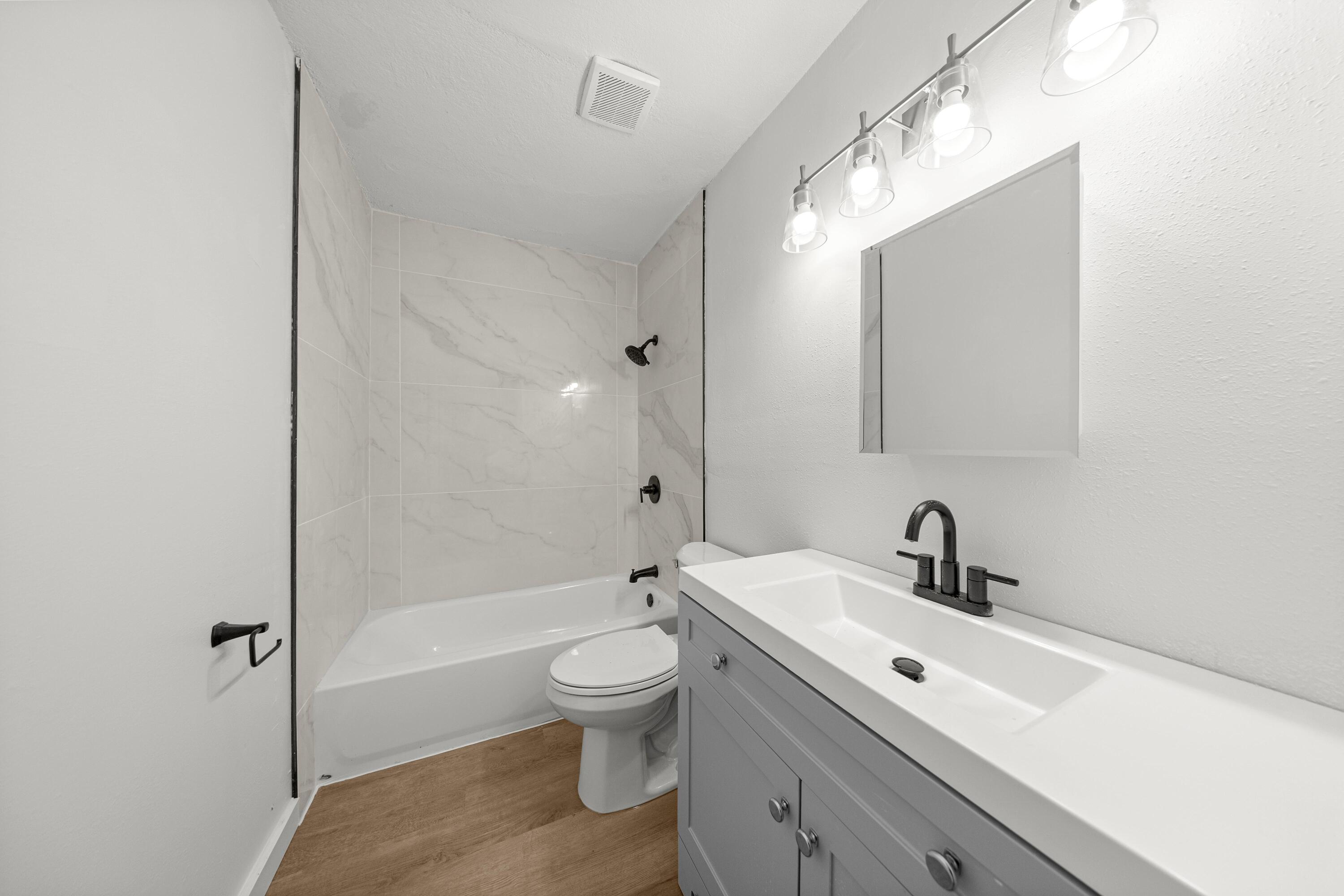 2931 Southeast 52nd Avenue Ocala, FL 34480 - Photo 13 of 52 a bathroom with a sink a toilet and shower