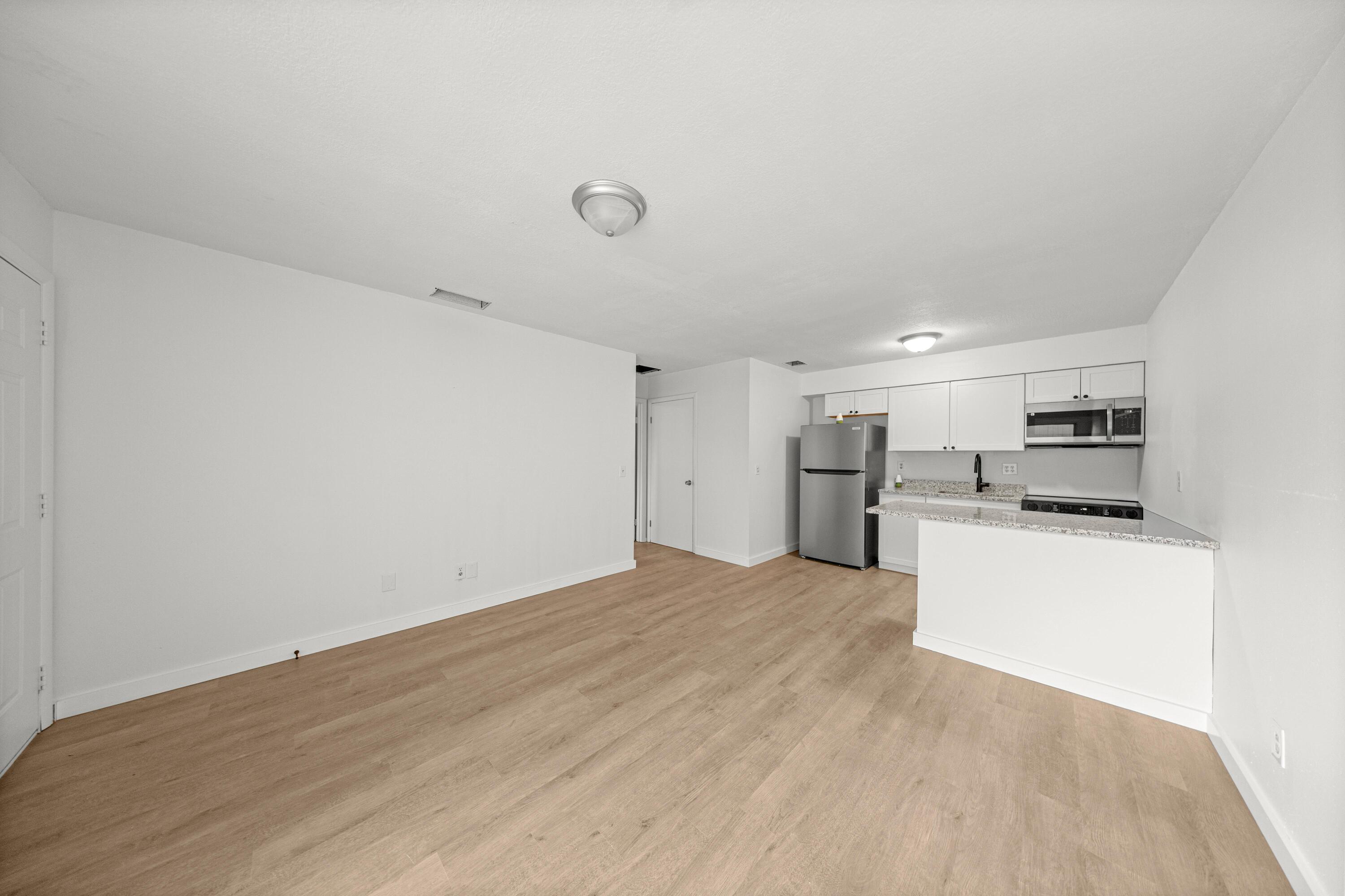 2931 Southeast 52nd Avenue Ocala, FL 34480 - Photo 22 of 52 a view of a kitchen with a sink and dishwasher a refrigerator with white cabinets