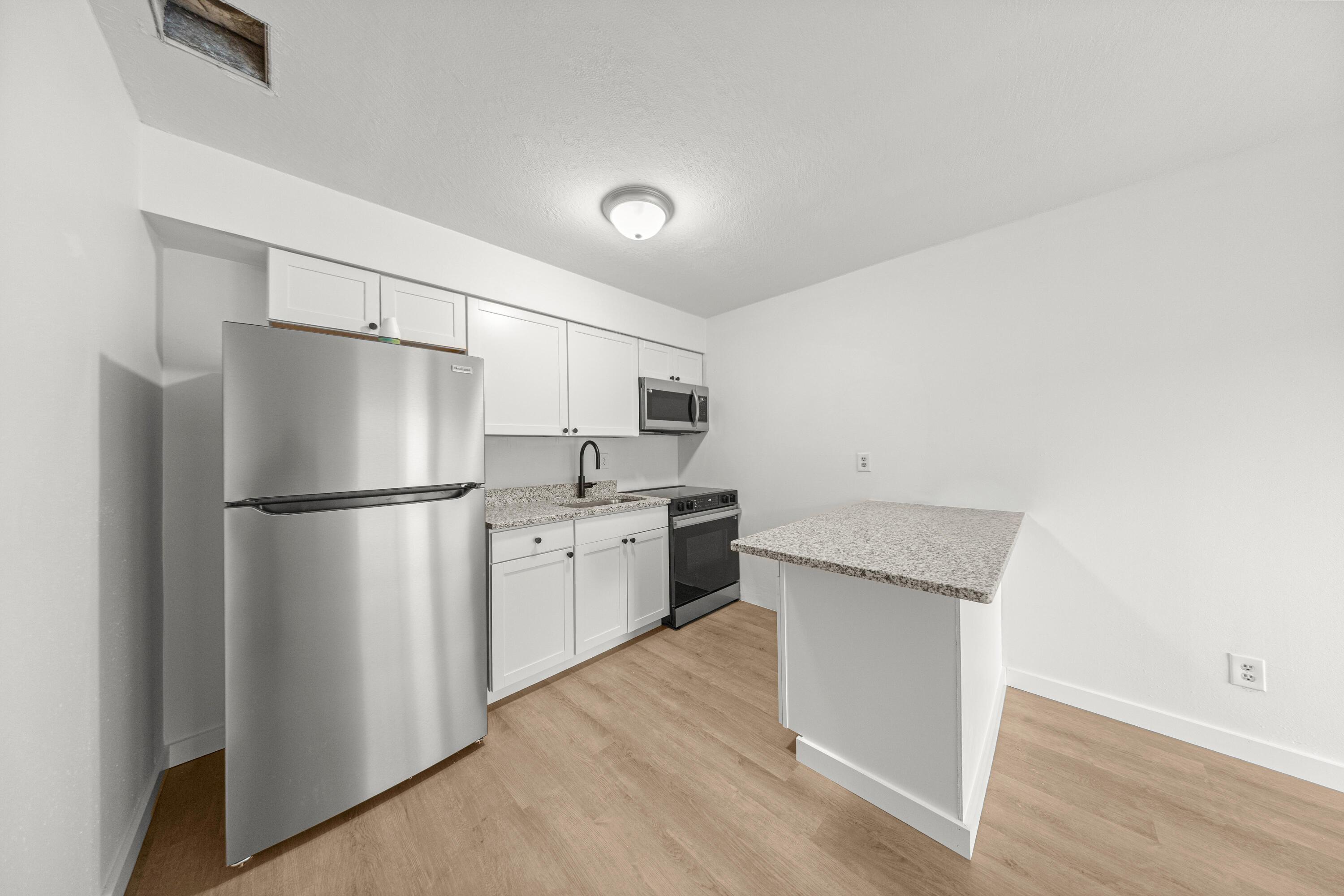 2931 Southeast 52nd Avenue Ocala, FL 34480 - Photo 23 of 52 a kitchen with a refrigerator sink and cabinets