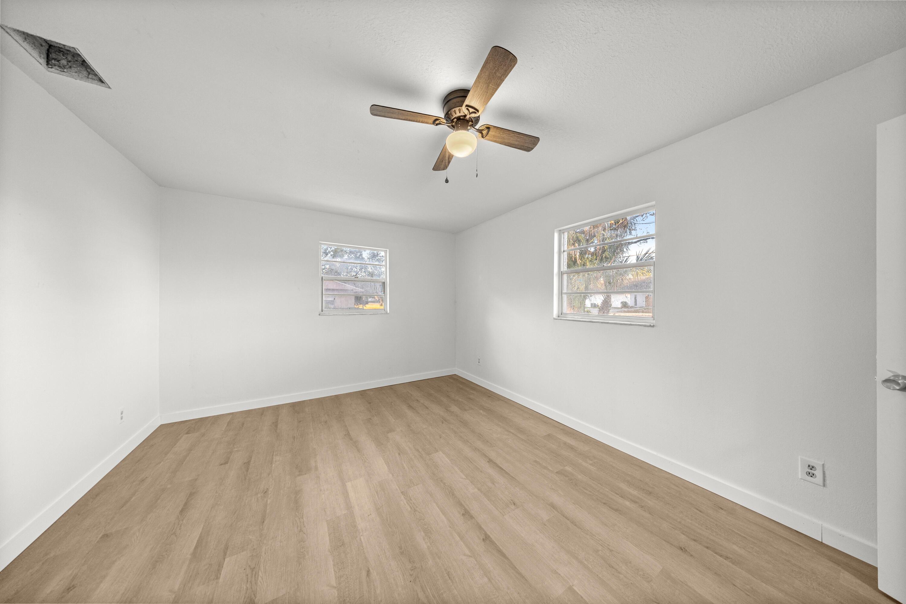 2931 Southeast 52nd Avenue Ocala, FL 34480 - Photo 26 of 52 an empty room with wooden floor and ceiling fan