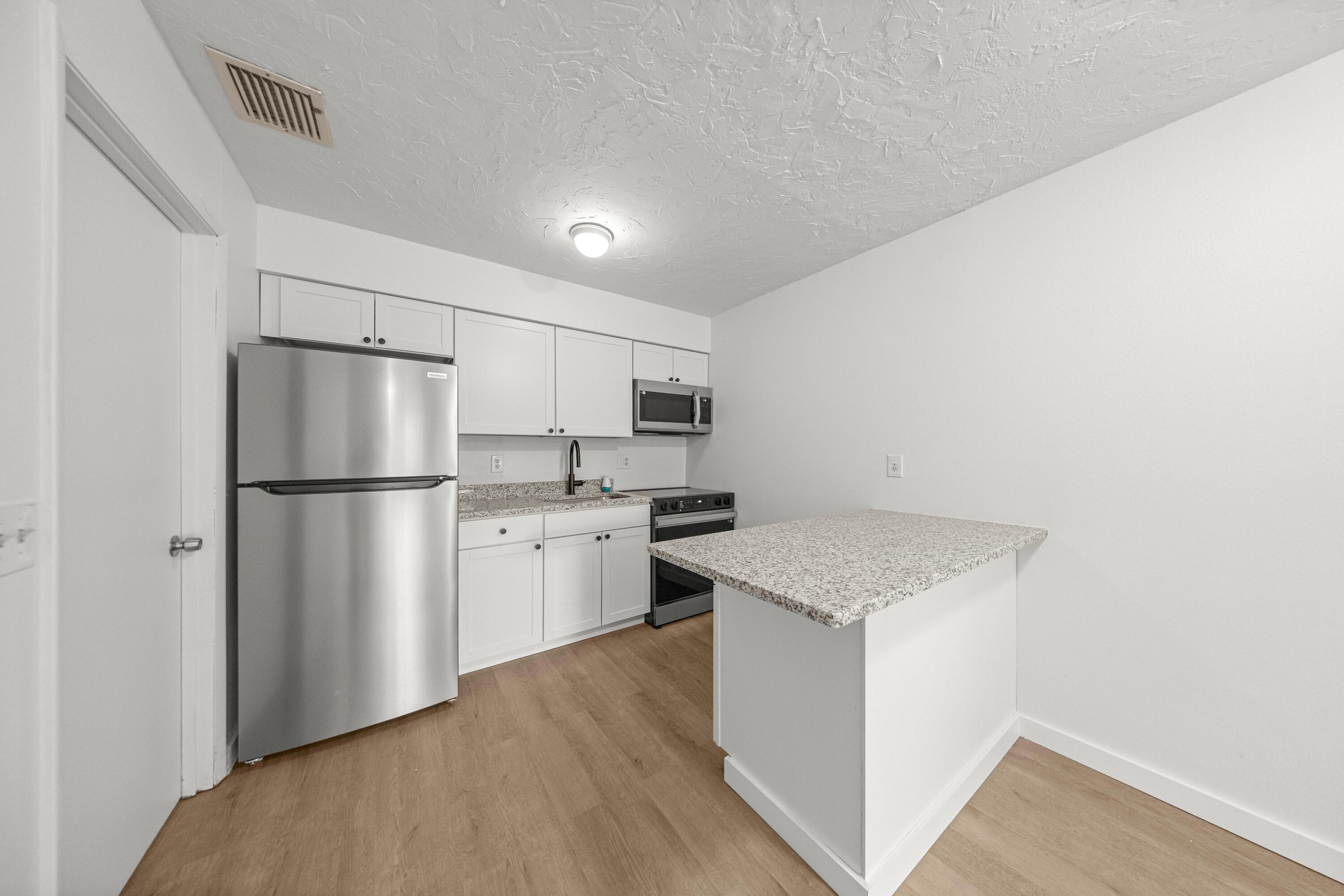 2931 Southeast 52nd Avenue Ocala, FL 34480 - Photo 43 of 52 a kitchen with a refrigerator sink and cabinets