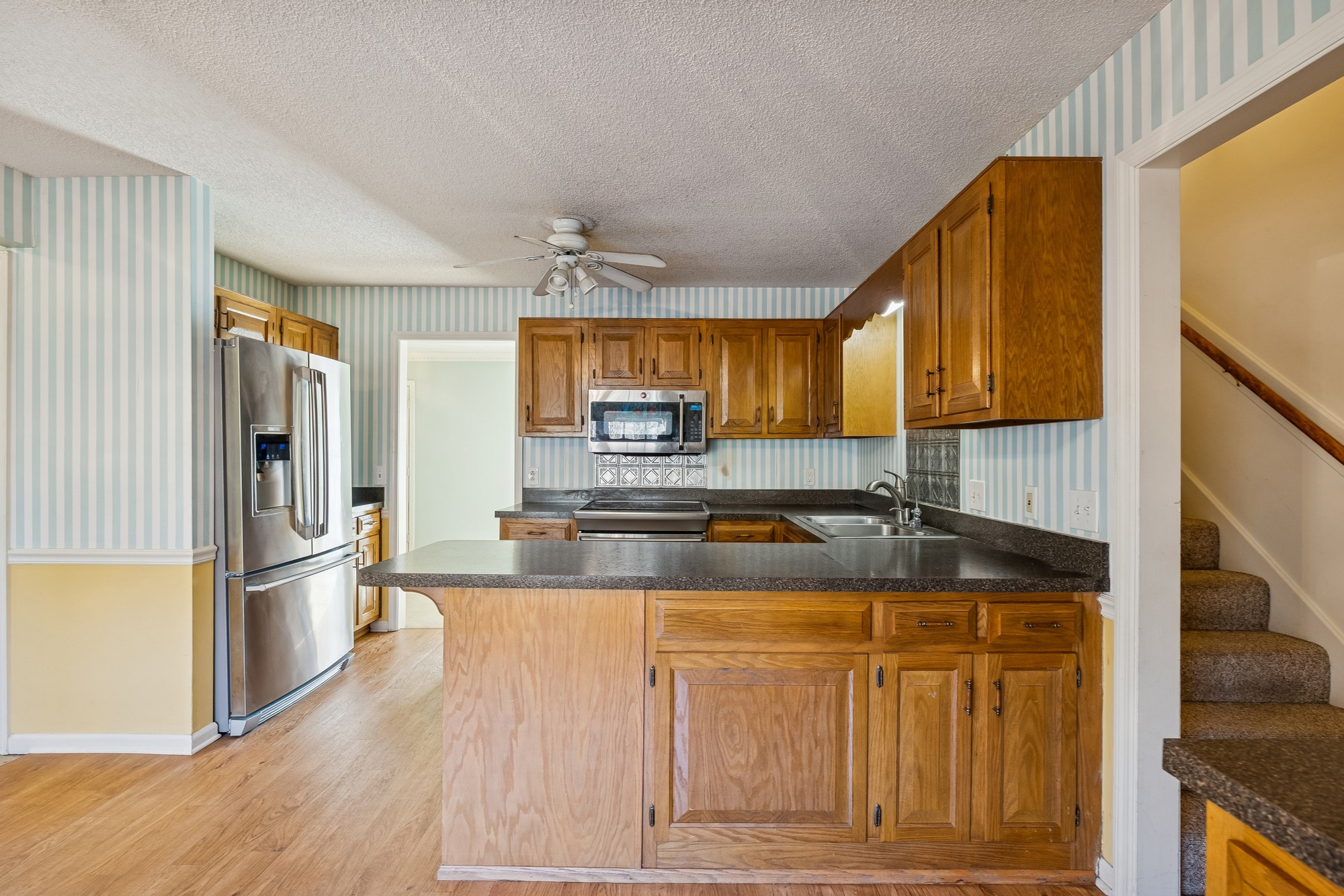 3508 Daisy Trail Antioch, TN 37013 - Photo 20 of 46 a kitchen with stainless steel appliances granite countertop a sink a refrigerator and a stove