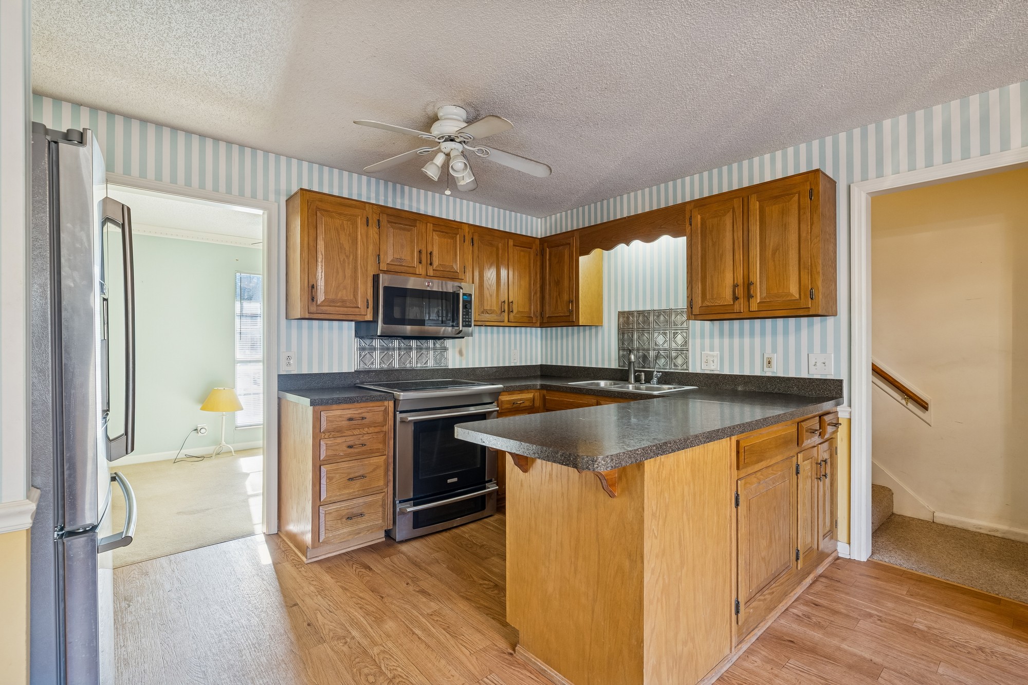 3508 Daisy Trail Antioch, TN 37013 - Photo 21 of 46 a kitchen with granite countertop a sink cabinets stainless steel appliances and a window