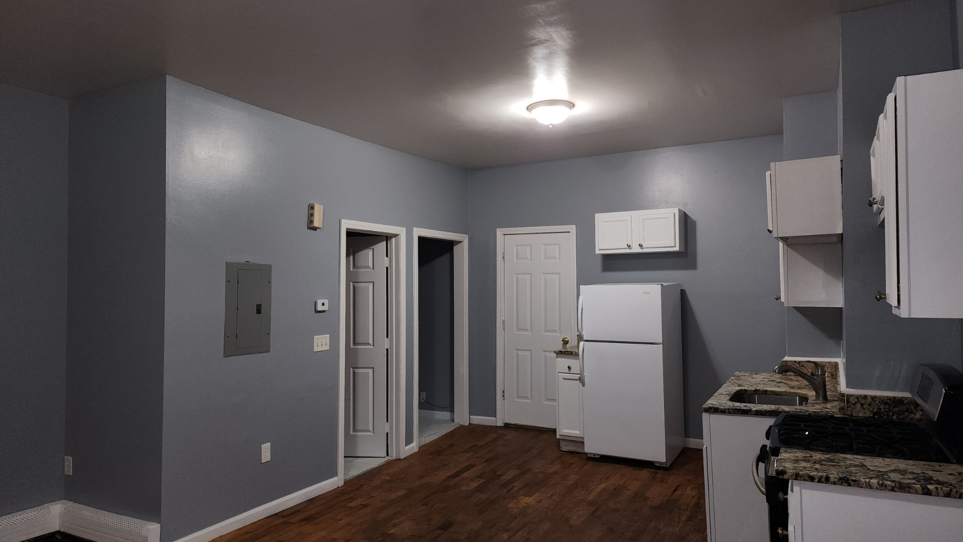 a kitchen with a refrigerator and a stove