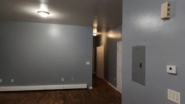 an empty room with an empty space and wooden floor