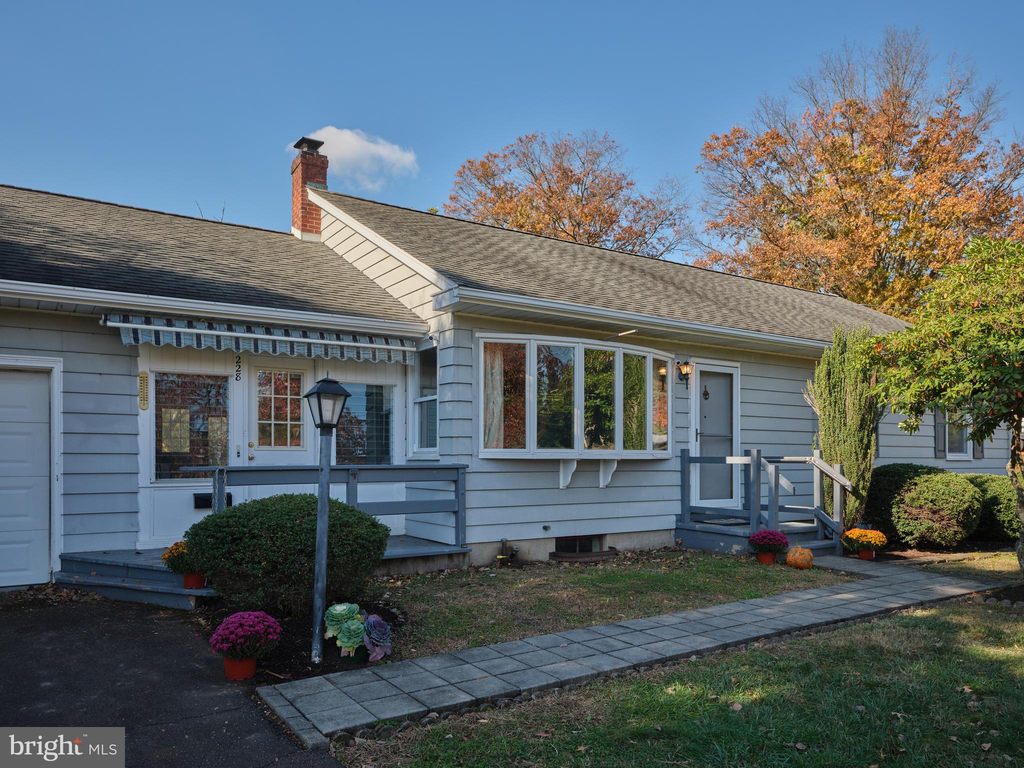 a front view of a house with a yard and outdoor seating
