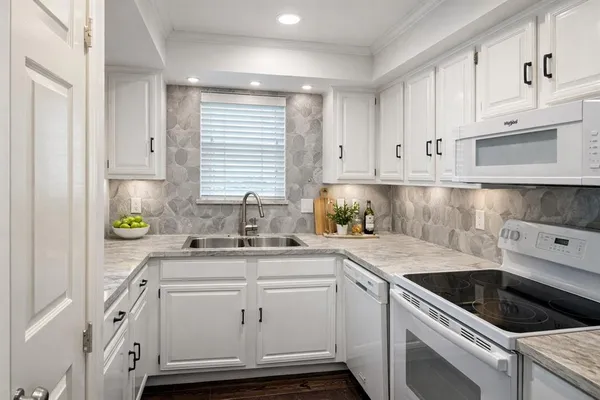 a kitchen with a sink stove and cabinets