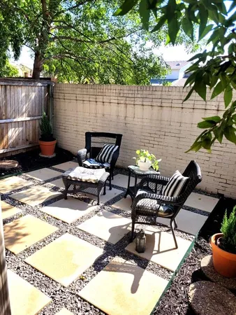 a view of a backyard with furniture and outdoor seating