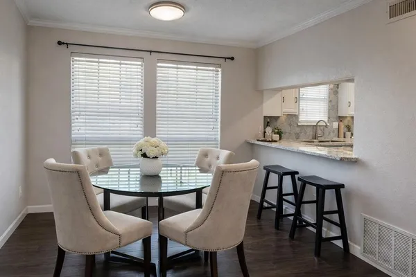 a dining room with furniture and wooden floor