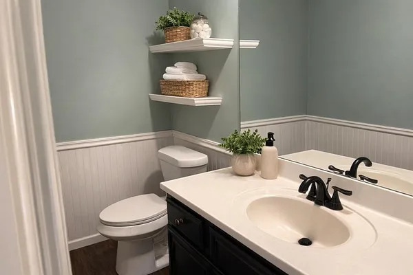 a bathroom with a sink a toilet and mirror