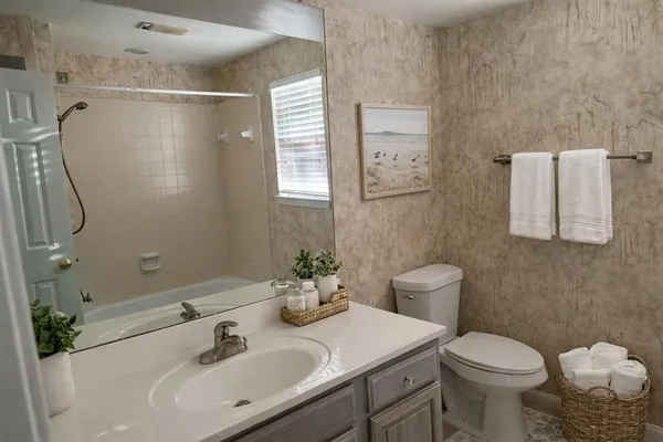 a bathroom with a sink toilet and shower