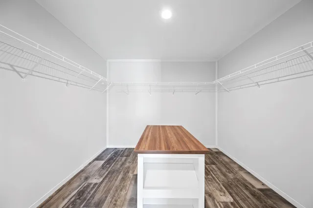 a view of a room with wooden floor