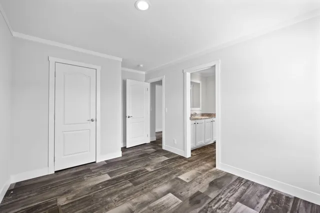 a view of a room with wooden floor and bathroom