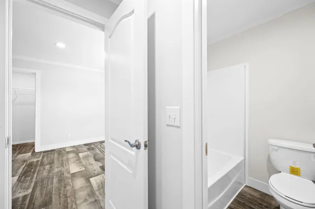 a bathroom with a bathtub and toilet