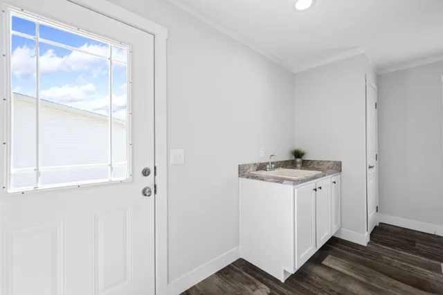 a room with a sink and a mirror