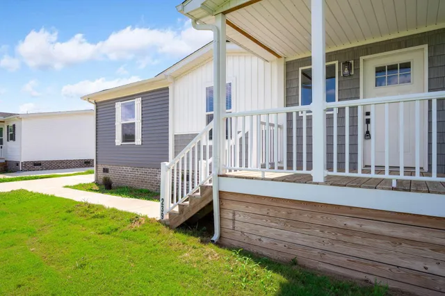a view of a house with backyard and porch
