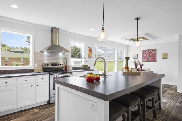 a kitchen with sink cabinets and stove