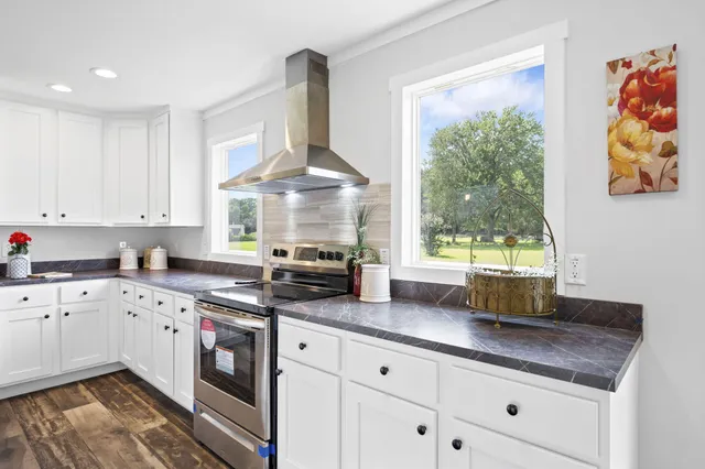 a kitchen with granite countertop a stove a sink and a granite counter tops