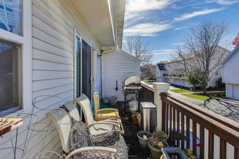 a view of a patio with table and chairs with wooden fence