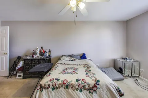 a bedroom with a bed and a chandelier