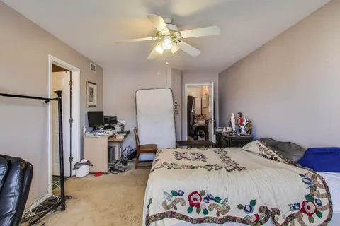 a bed room with a bed and a chair