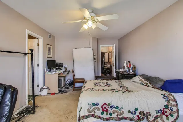 a bed room with a bed and a chair